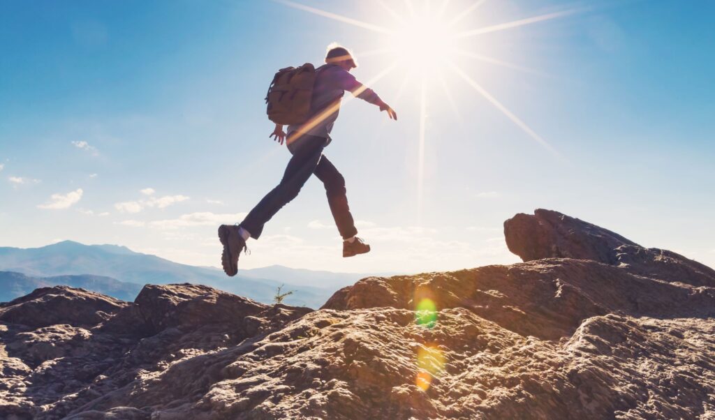 man jumping over rocks