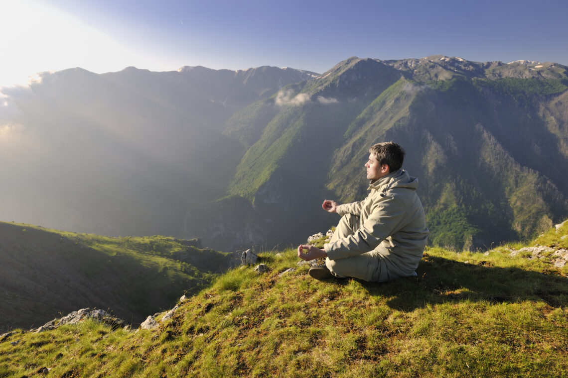 man meditating in nature