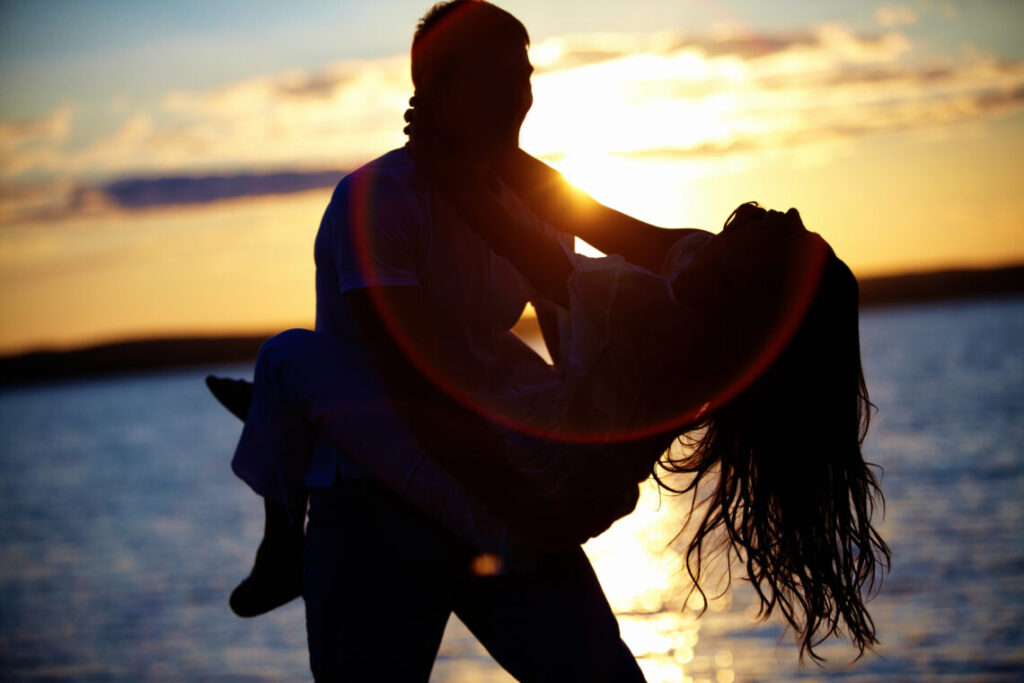 happy couple silhouette in the sunset